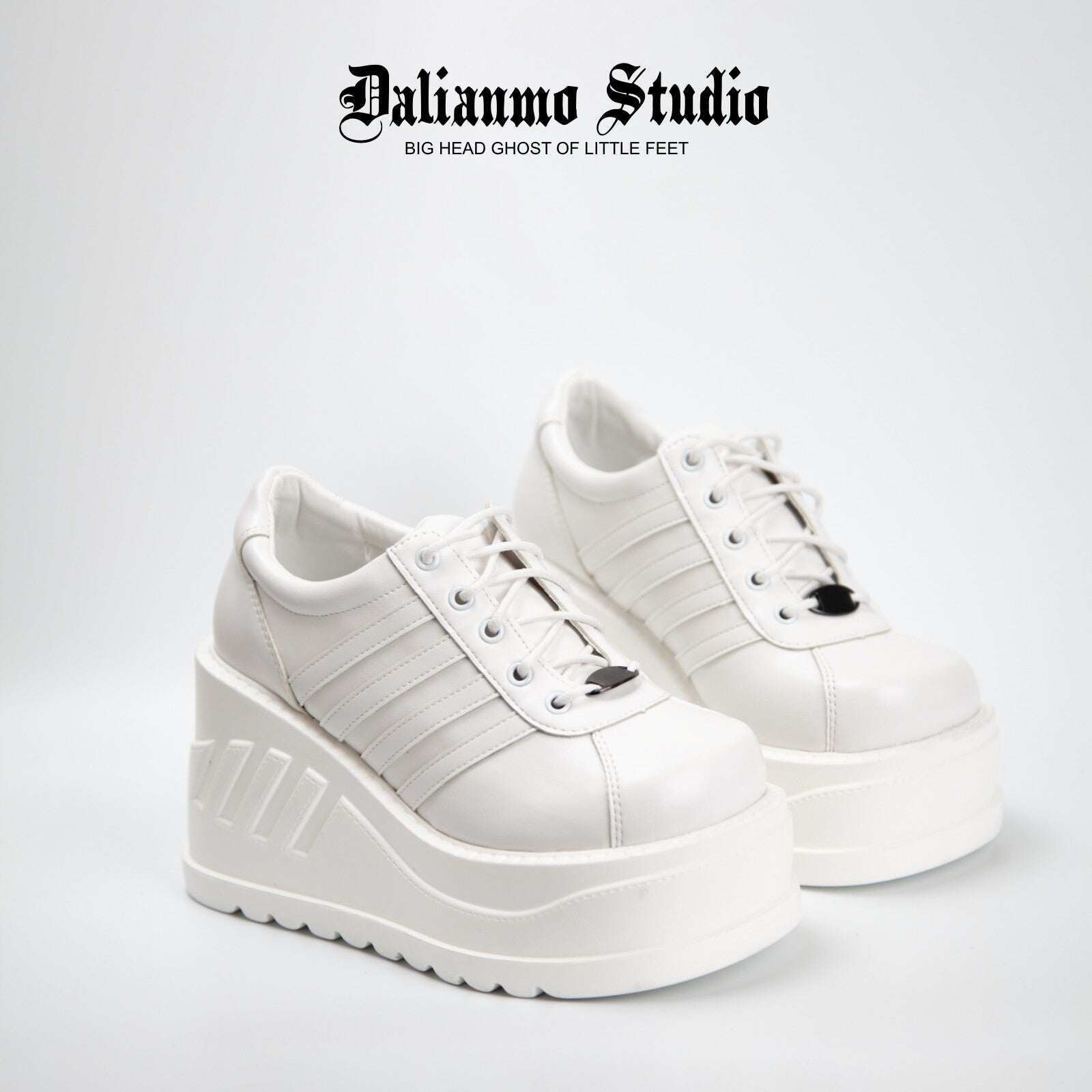 White platform lace-up sneakers with three stripe panels and thick tread sole