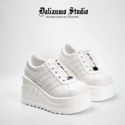 White platform lace-up sneakers with three stripe panels and thick tread sole