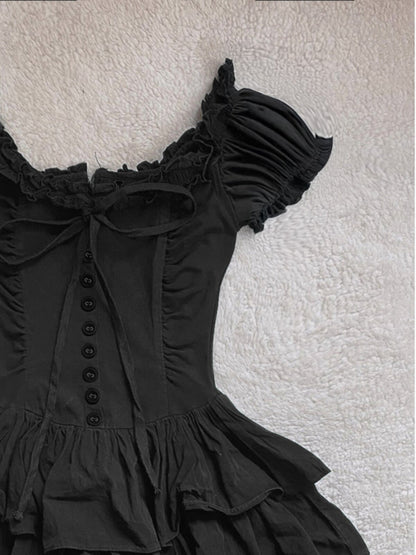 Black corset bodice dress with button row, ribbon tie, and ruffled shoulder sleeves