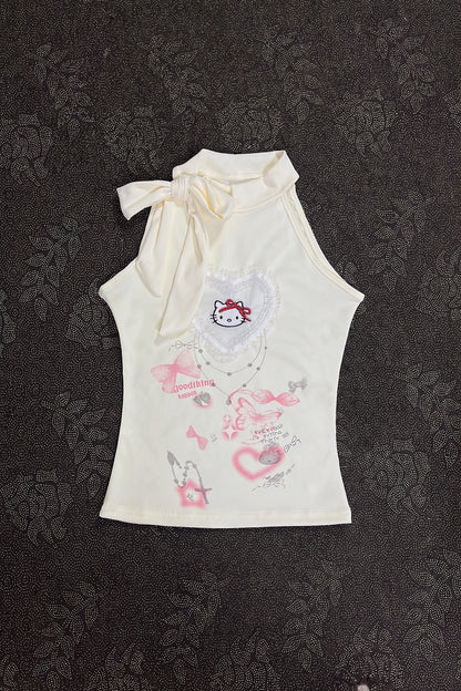 Cream sleeveless girls top with ribbon bow neckline and kitty heart graphic