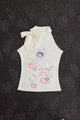Cream sleeveless girls top with ribbon bow neckline and kitty heart graphic