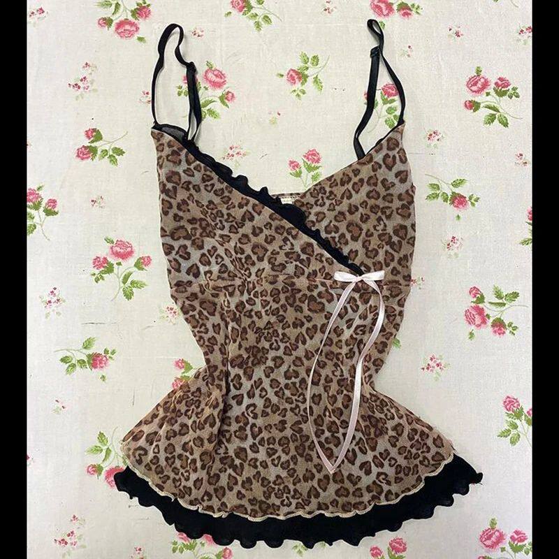 Leopard print slip dress with thin straps, black lace trim, back tie and flutter hem