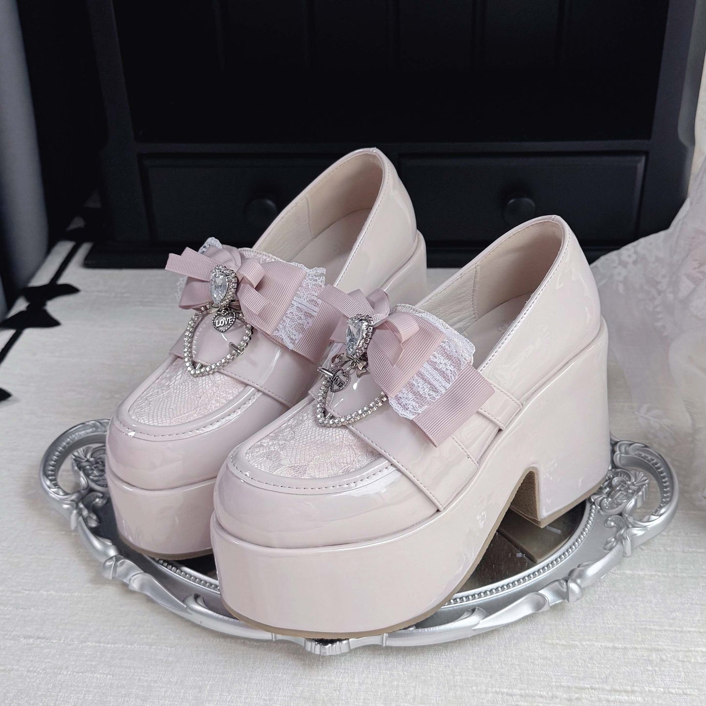 Light pink lace platform loafers with bow and heart charm accents