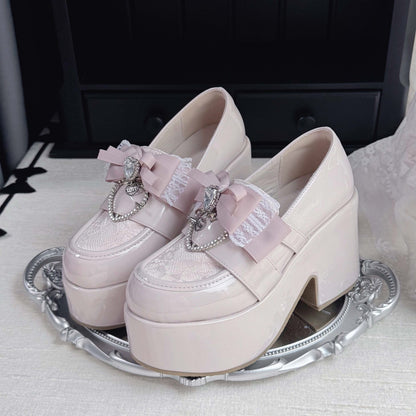 Light pink lace platform loafers with bow and heart charm accents