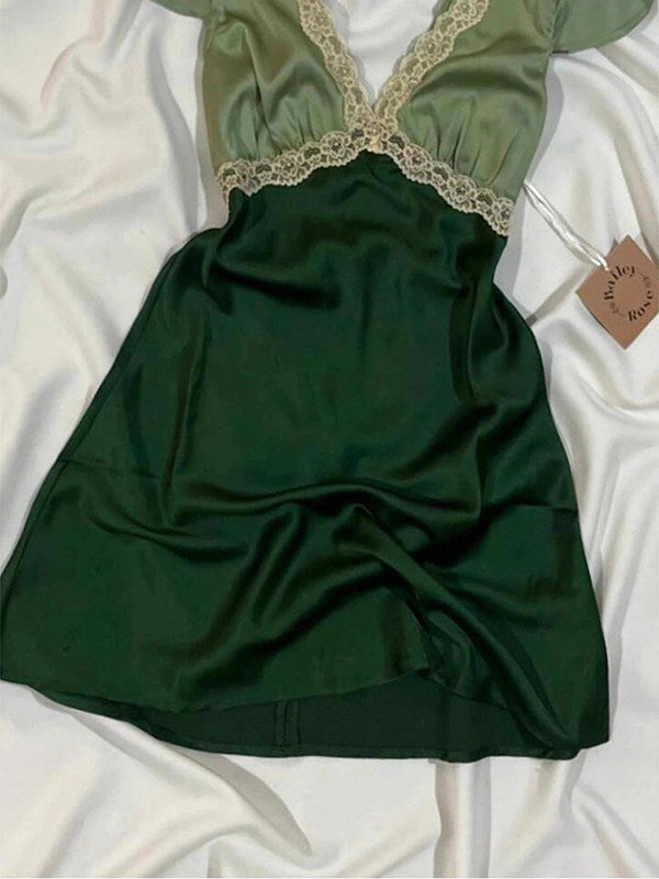 Green satin mini dress with lace V-neck and puff sleeves, gathered flared skirt.