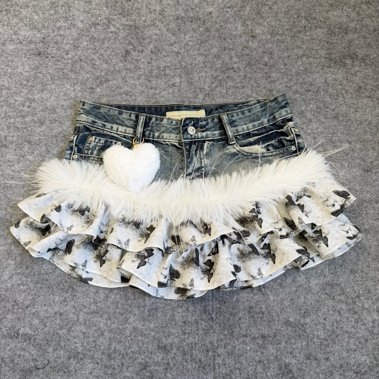 Ruffled denim skirt with butterfly print, wide faux-fur hem, heart charm