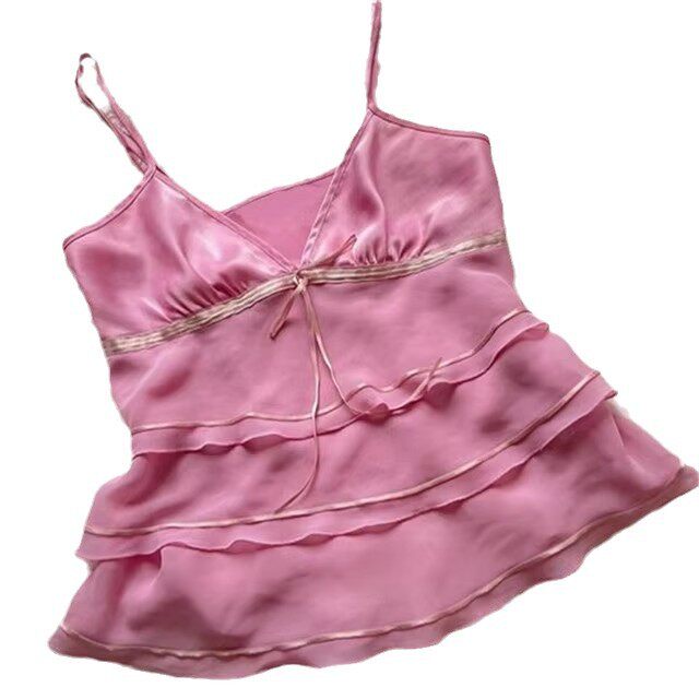 Pink satin tiered slip dress with spaghetti straps and center tie bow