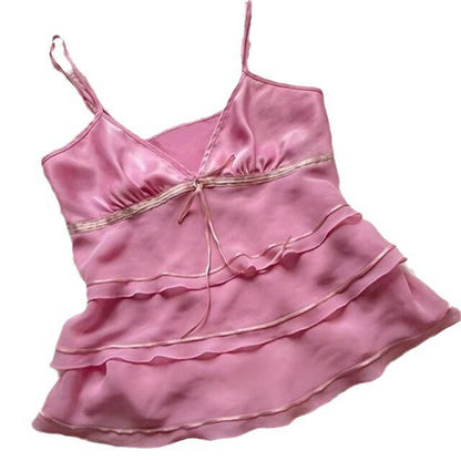 Pink satin tiered slip dress with spaghetti straps and center tie bow
