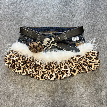 Leopard print denim skirt with white faux-fur hem and studded black belt with metal pendant