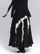 Black maxi skirt with asymmetrical tiers and layered white ruffle panels