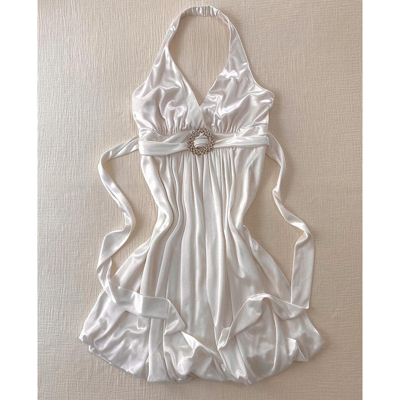 White halterneck slip dress with draped satin bodice and ornate belt buckle at waist
