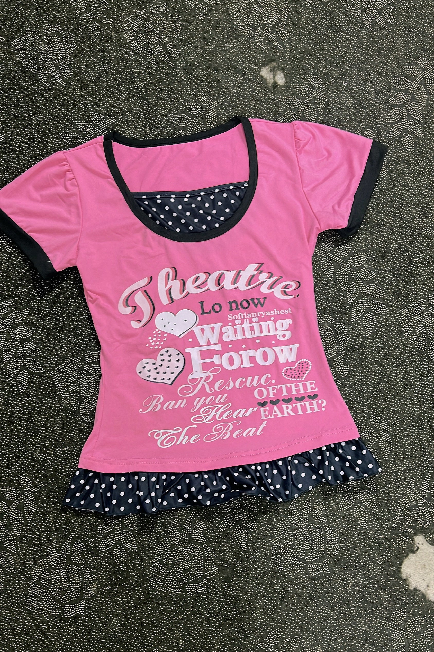 Pink T-shirt with black-trim scoop neck, heart letter graphic and polka-dot ruffle hem