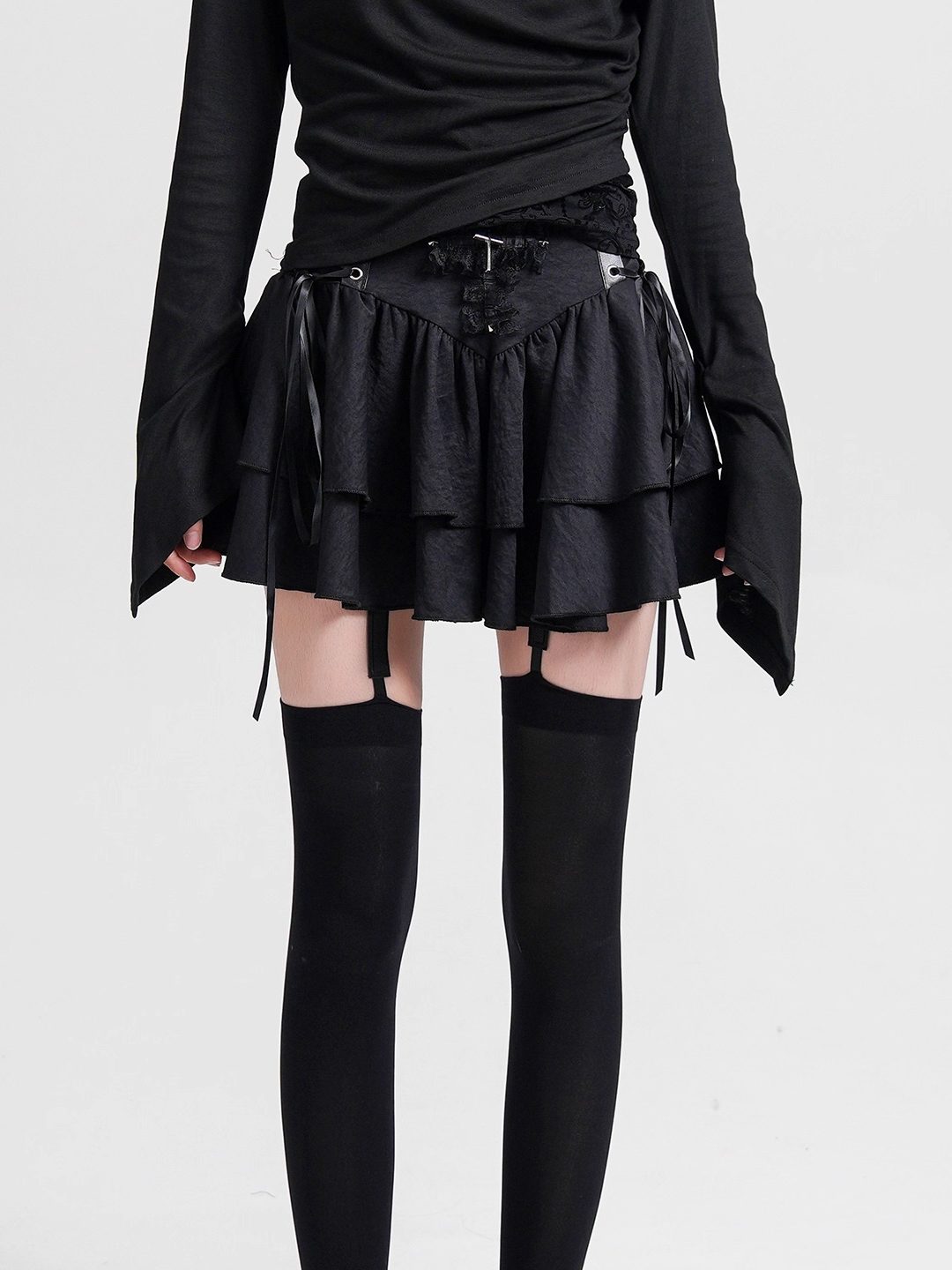Black cake skirt with tiered ruffle skirt and lace-up waist ties.