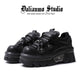 Black gothic platform flats with lace-up front, strap, and chunky lug sole