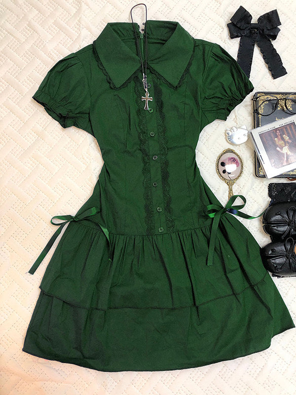 Green lace patchwork dress with short puff sleeves, button front, and tiered skirt.