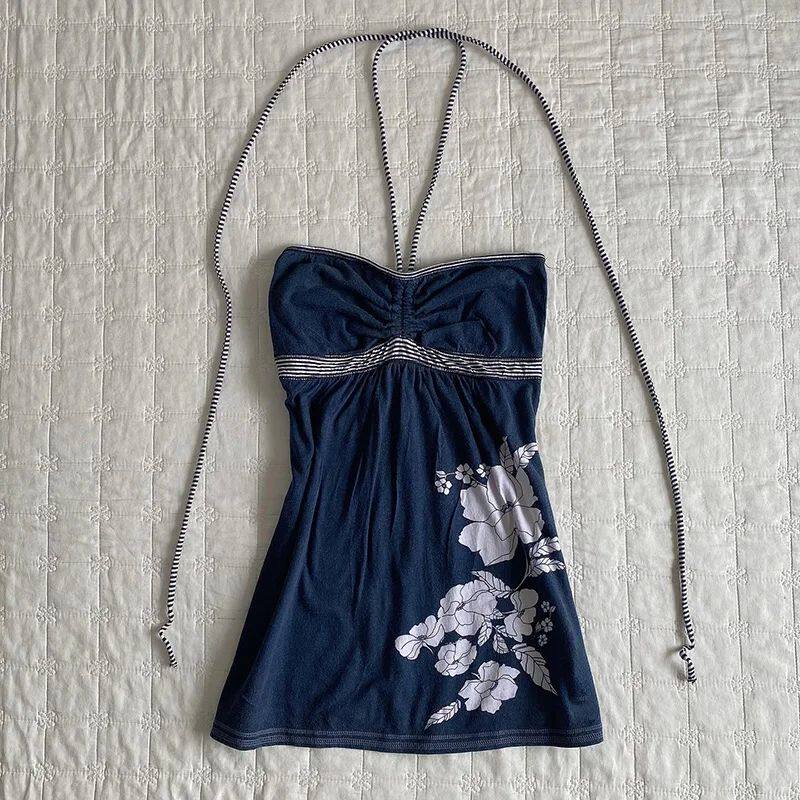 Navy bandeau dress with white floral print, gathered bust, and tie shoulder straps