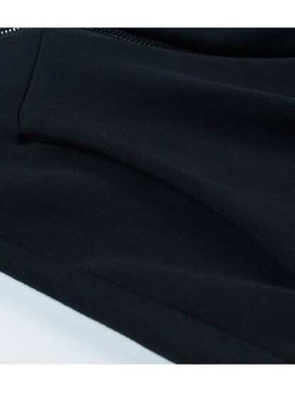 Black hooded sweater fabric close-up with stitched seam and hem