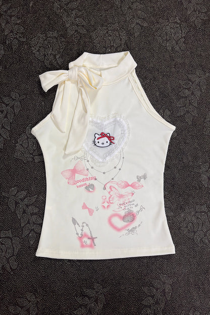Cream sleeveless girls top with knot bow at neck and pastel kitty print
