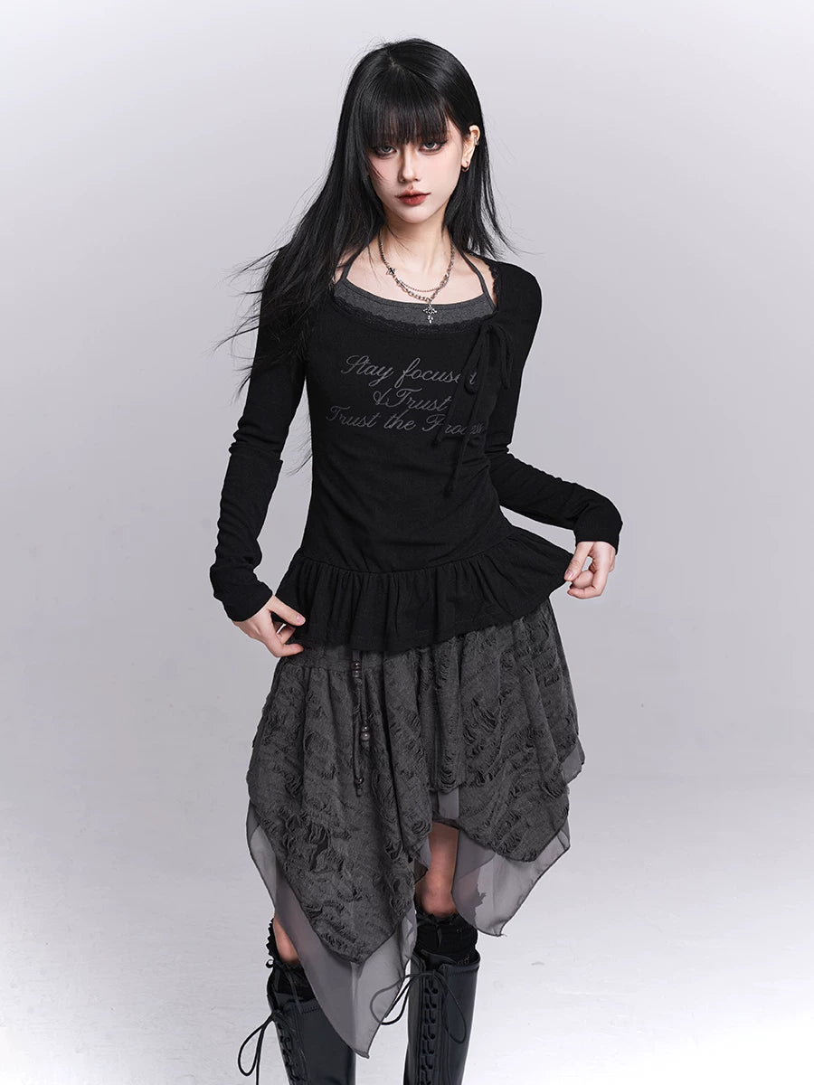 Black long-sleeve tunic with ruffled waist and dark asymmetrical skirt panels