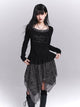 Black long-sleeve tunic with ruffled waist and dark asymmetrical skirt panels