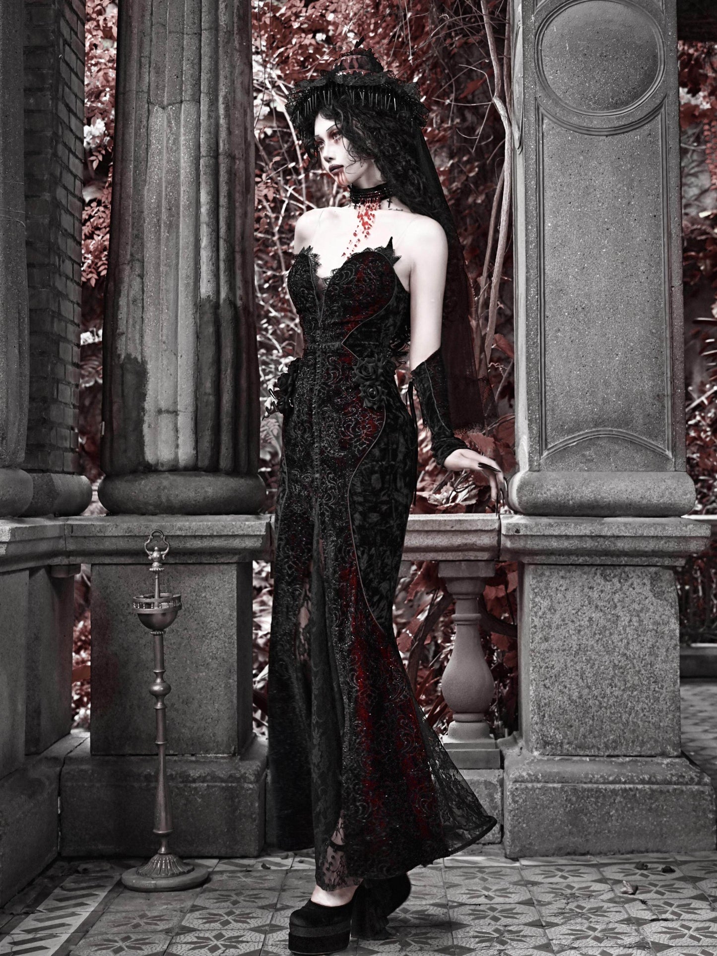 Black gothic corset maxi dress with red embroidery, sleeveless fitted bodice and long skirt.