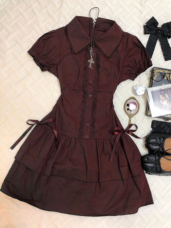 Burgundy lace patchwork dress with short puff sleeves, button front, and tiered skirt.