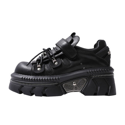 Black platform flats with lace-up, wide hook strap, and metal eyelets on lug sole