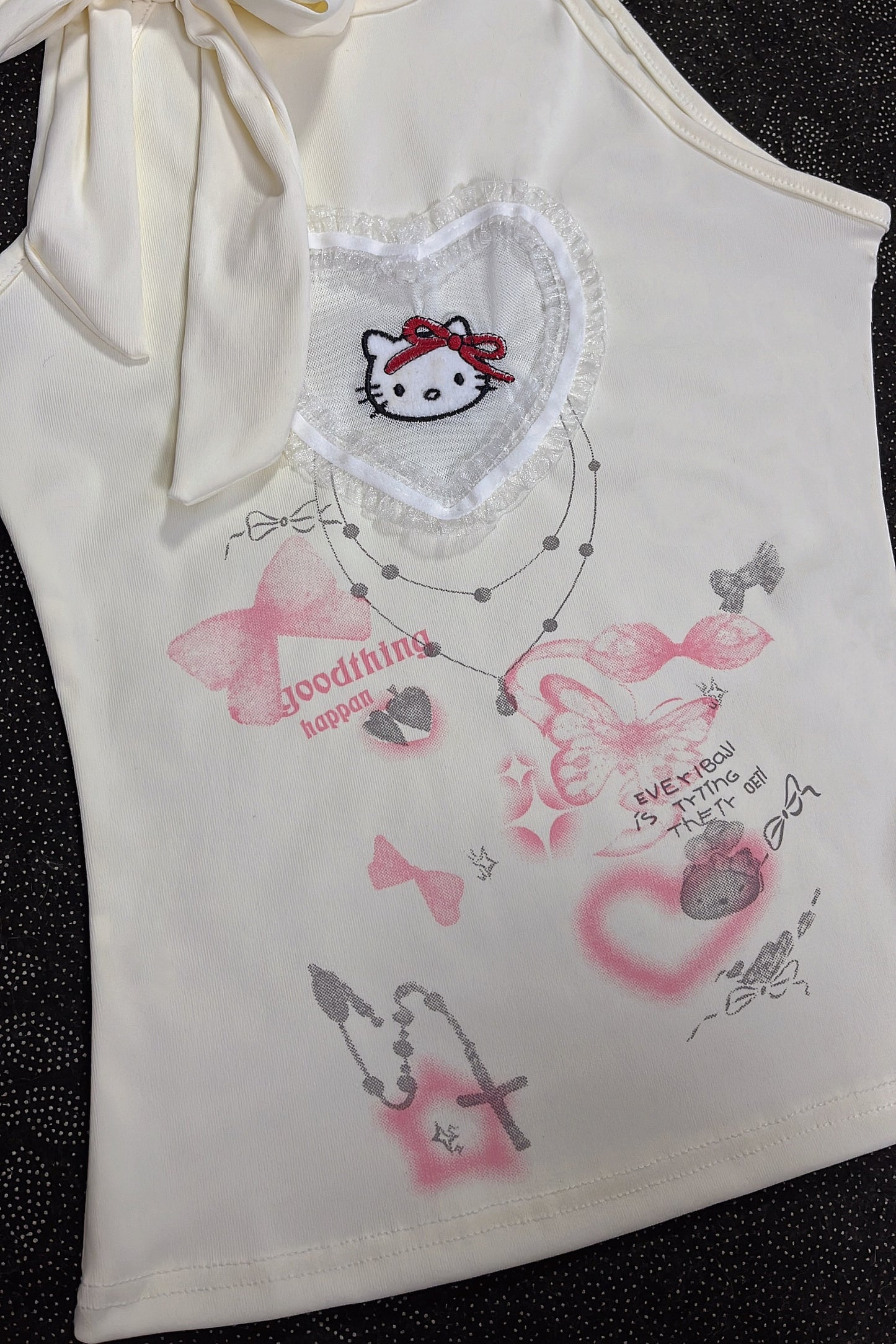 Cream sleeveless girls top with lace heart patch and pastel icons lettering