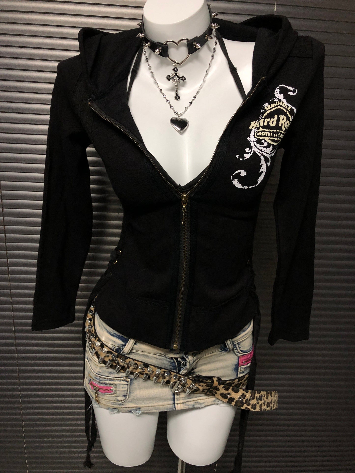 Black zip-up hooded sweatshirt jacket with chest graphic and gold zipper