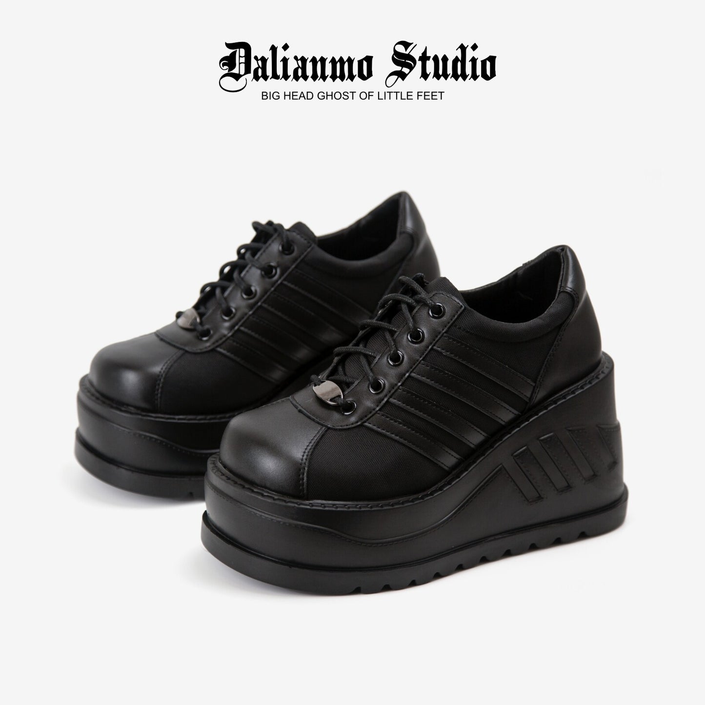 Black platform lace-up sneakers with ribbed stripes and thick tread sole
