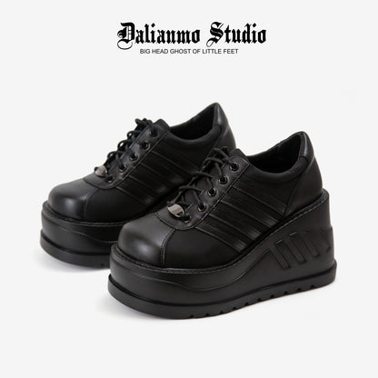 Black platform lace-up sneakers with ribbed stripes and thick tread sole