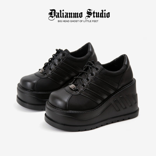 Black platform lace-up sneakers with ribbed stripes and thick tread sole
