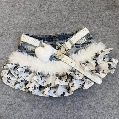 Denim skirt with butterfly print ruffles, studded straps, white faux-fur trim, heart charm