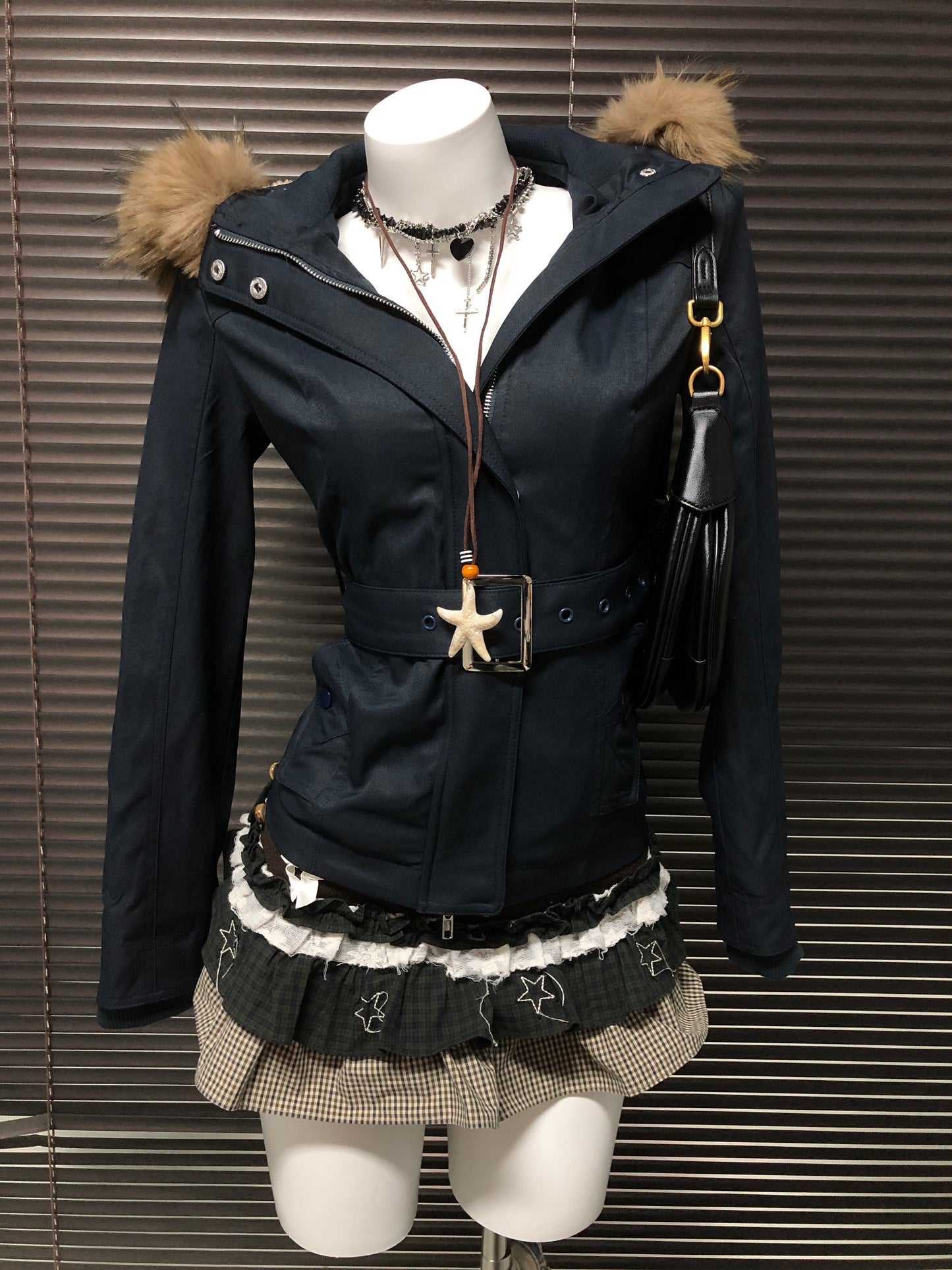 Black hooded parka jacket with faux fur hood trim, front zip, and gold-buckle belt
