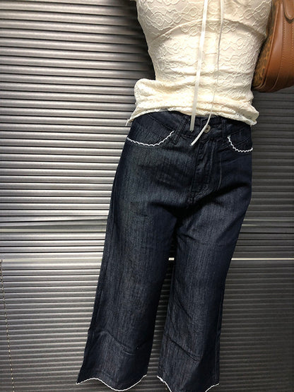 Dark blue cropped jeans with slight flare leg and scalloped hem edge