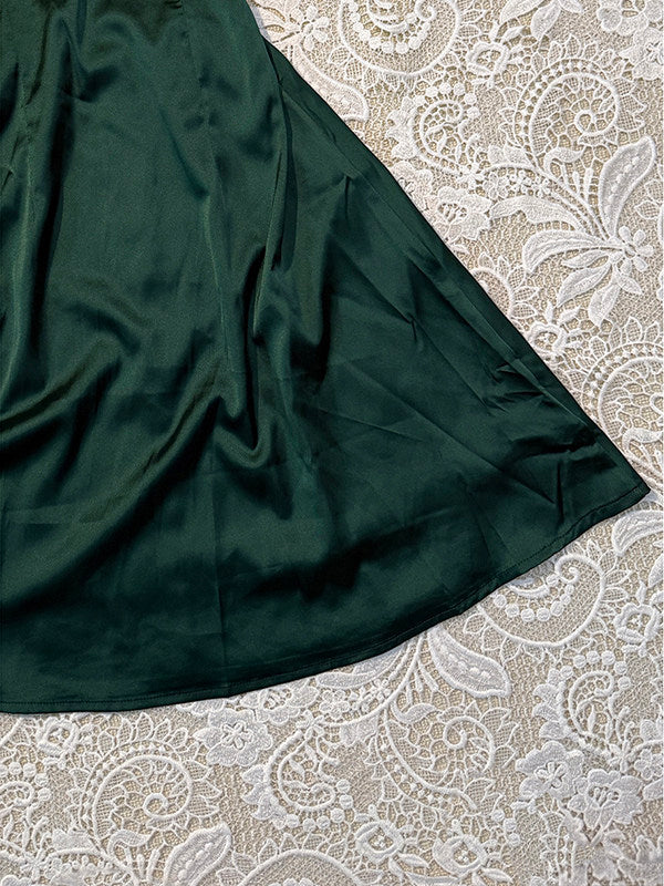 Dark green satin dress skirt with gathered fabric and smooth drape to hem