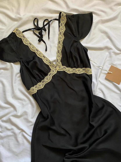 Black lace V-neck mini dress detail: lace trim along neckline, tie-back straps.