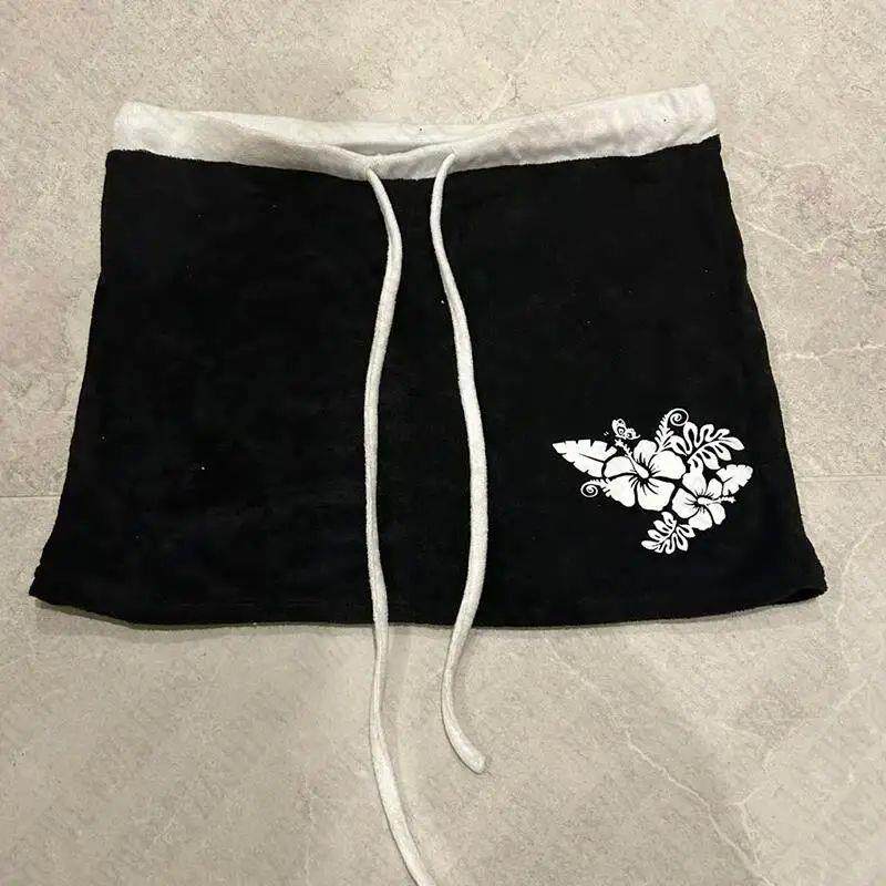 Black mini skirt with white drawstring ties and floral print on hem