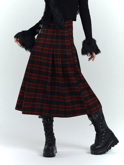 Flared long A-line plaid skirt in red and black tartan, side buckle straps at hem