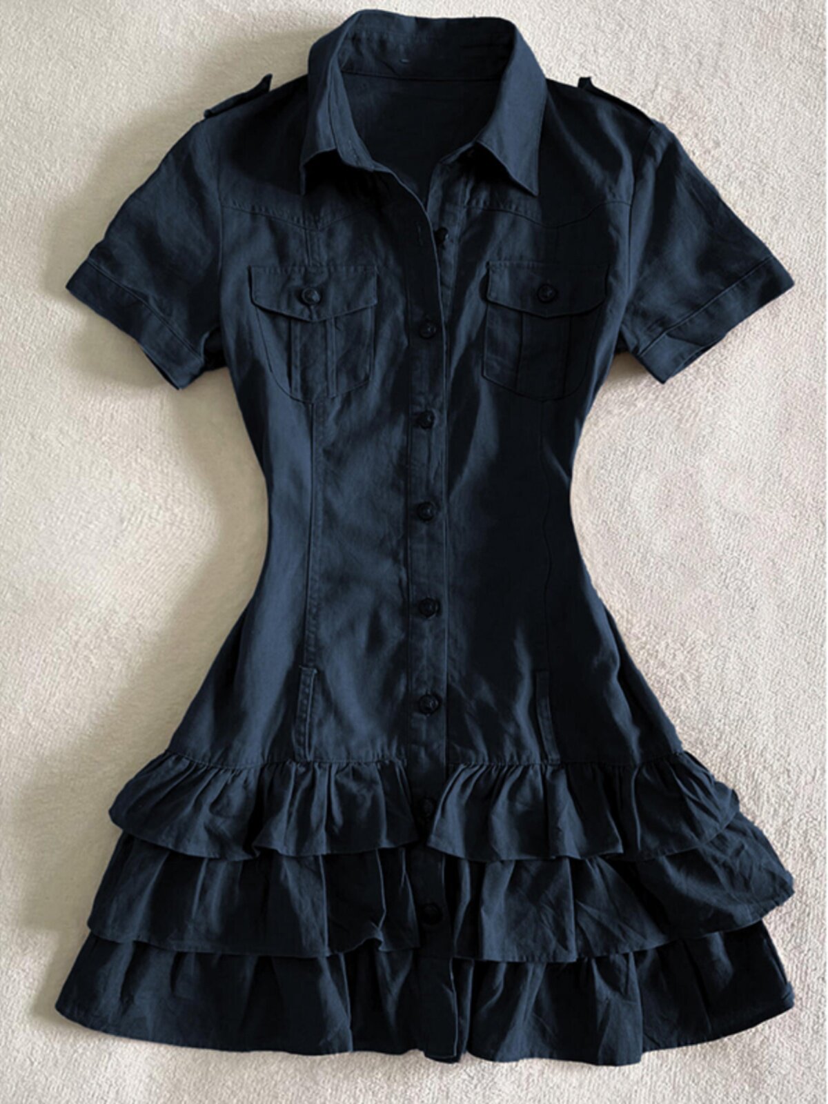 Dark blue button-front shirt dress with chest pockets and tiered ruffle hem