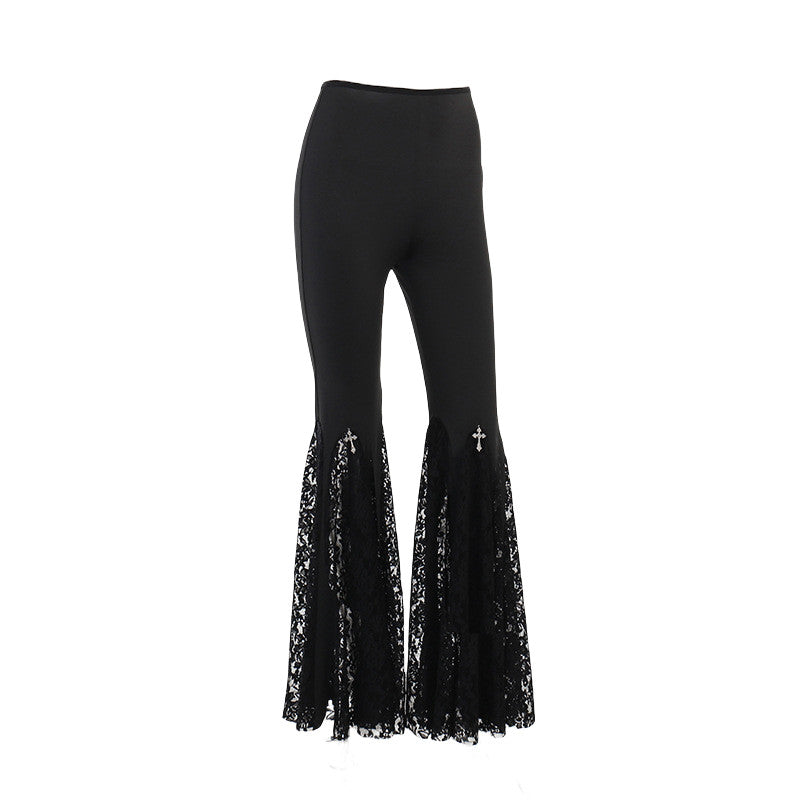 High-rise black pants with lace bell-hem panels and cross-like embroidery at the flare