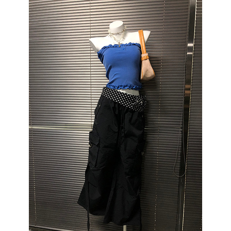 Black wide-leg pants with white polka-dot waistband trim and gathered waist