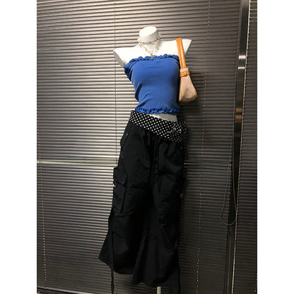 Black wide-leg pants with white polka-dot waistband trim and gathered waist