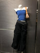 Black wide-leg pants with white polka-dot waistband trim