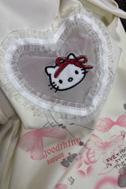 Hello Kitty heart patch with red bow on cream sleeveless top