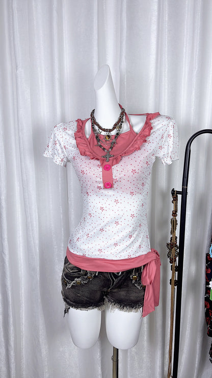 Pink flower print halterneck top with ruffled bib and button placket