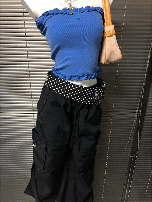 Black wide-leg pants with white polka-dot waistband and side pocket seams