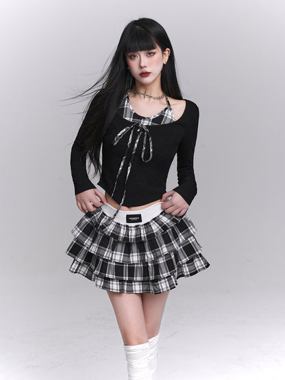 Black long-sleeve cropped top with plaid bow neckline and tiered check pleated skirt