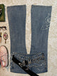 Light-blue micro-flare denim jeans with butterfly patches and black ribbon detail