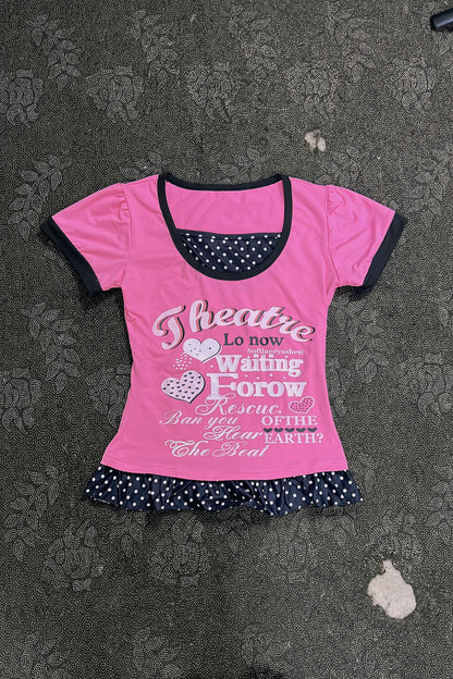 Pink T-shirt with black-trim neckline and polka-dot ruffle hem, heart letter graphic print